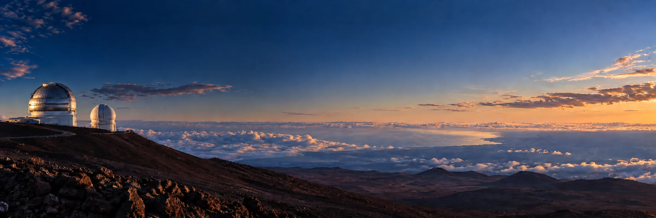 Photo-informed composite of Gemini and CFHT on Mauna Kea overlooking the distant Hilo coast